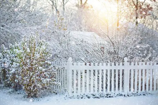 Cedar fence home winter snow