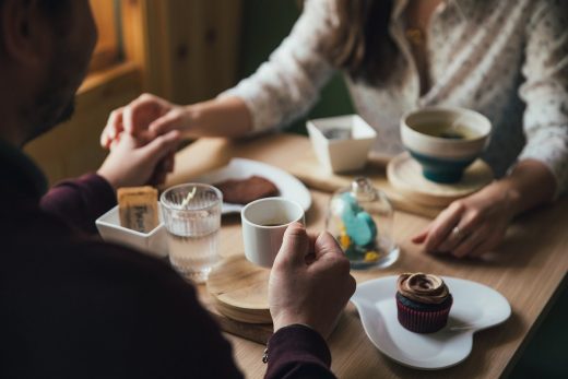 Woman man meeting table cake tea